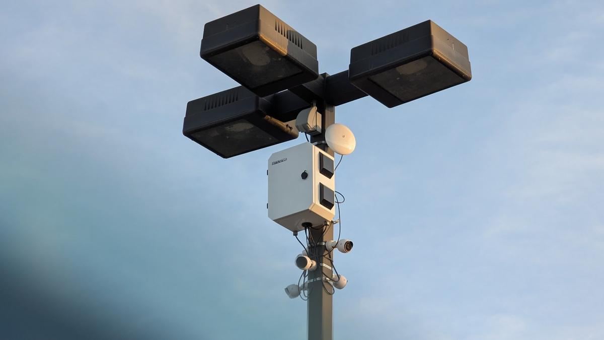 White camera enclosure on a light pole