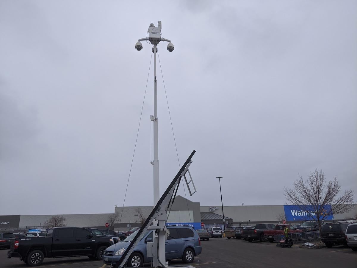 Surveillance mast above a store parking lot