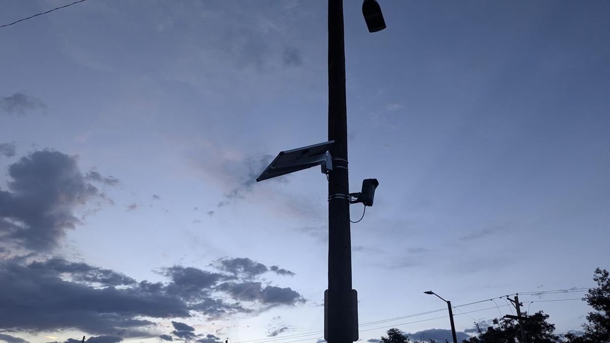 Camera and panel on a steel pole at dusk