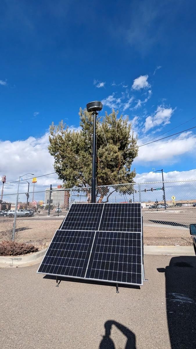 Tilted solar array with mast behind